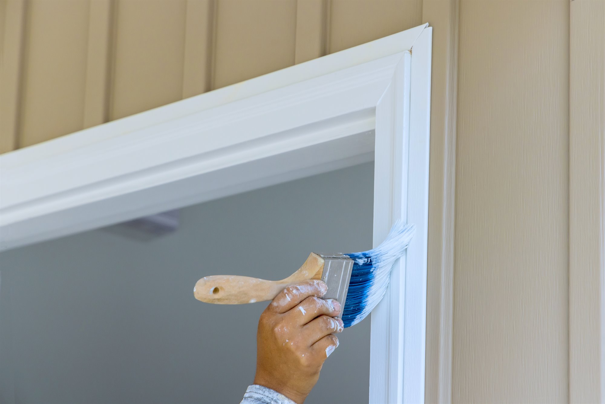 Woodwork and trim painting project on a hallway staircase